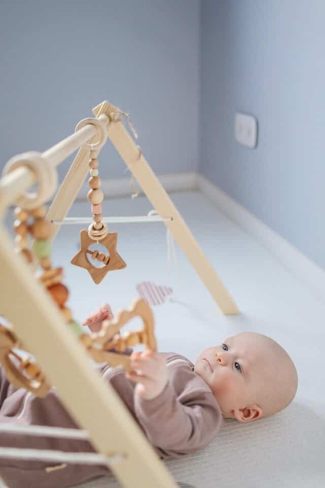 Use toys to help baby sit up